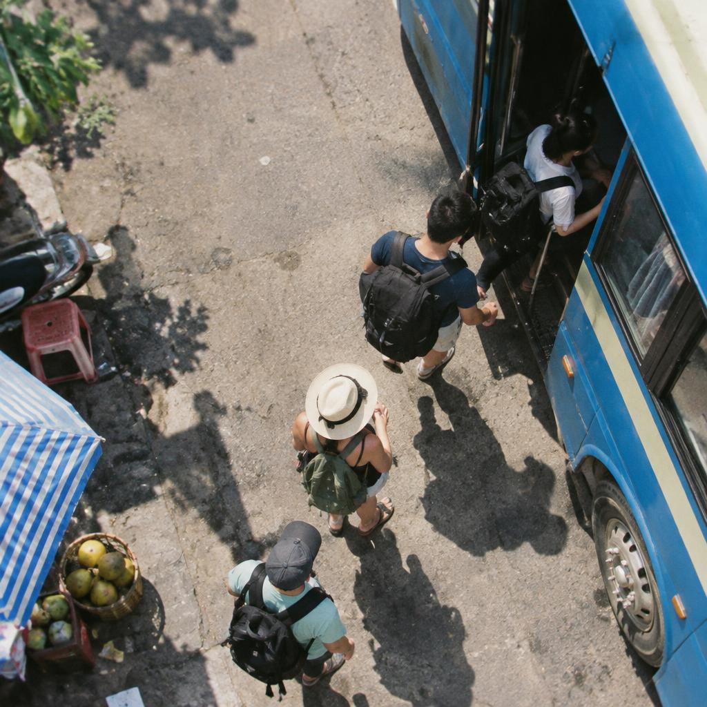 Tourists boarding a modern bus in Vietnam, ready for their journey, a common sight for the Vietnam bus travel guide 2026.